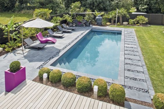 French pattern Bluestone tiles around a pool and deck area.
