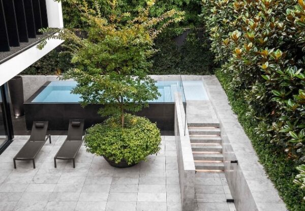 Light grey coloured pavers around an outdoor pool area.