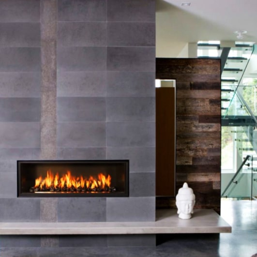 Bluestone wall cladding above a fireplace as a feature wall.