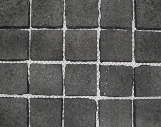 Bluestone cobblestones on mesh sheets.